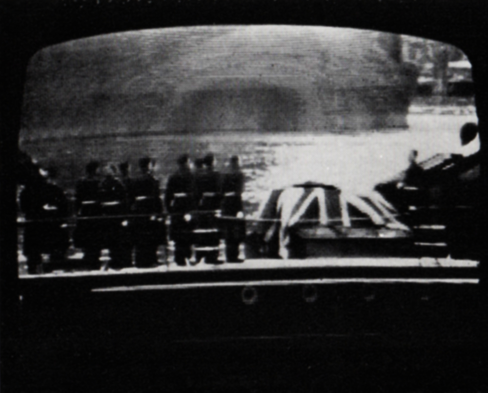 Tele-snap of the coffin on the barge